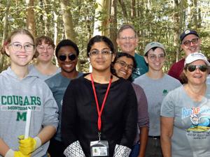 Volunteers plant native trees to bolster Curlis Woods